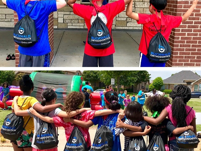 Group of kids wearing drawstring bags with Buchwald Orthodontics logo